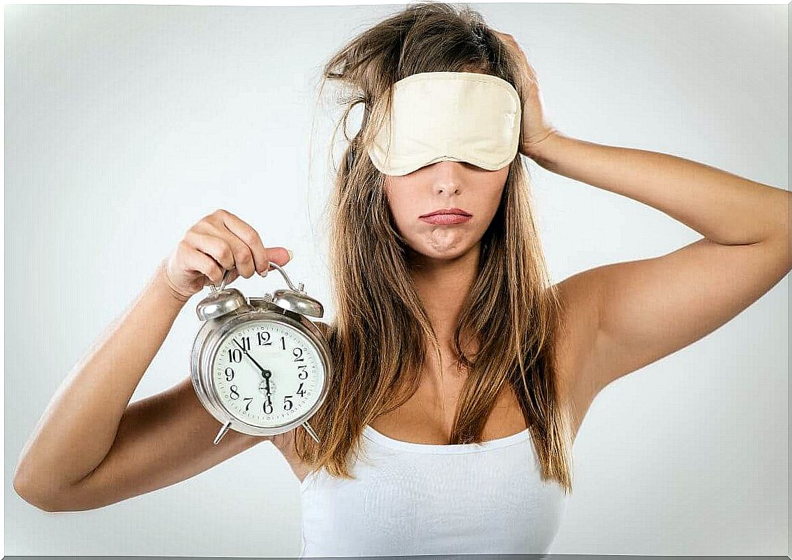 Woman with mask and alarm clock in hand