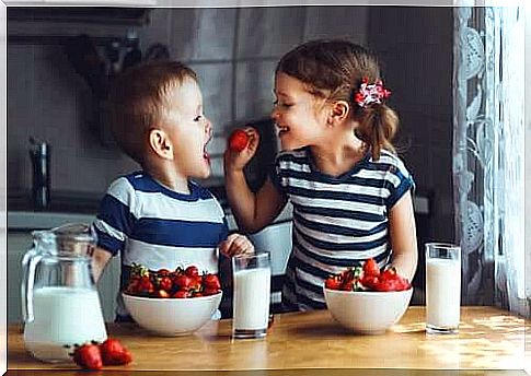 Brothers laughing in the kitchen.