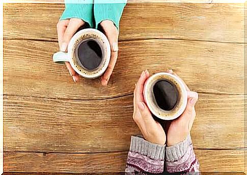 Hands with cups of coffee.