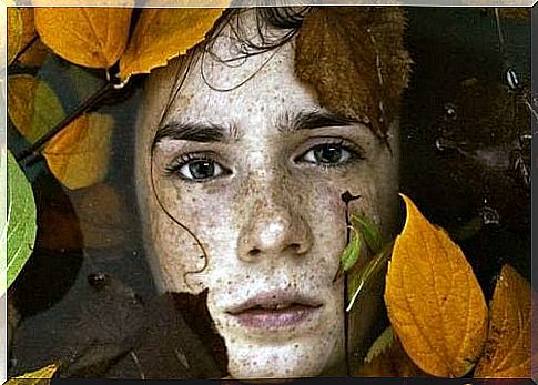 Face in the water surrounded by leaves