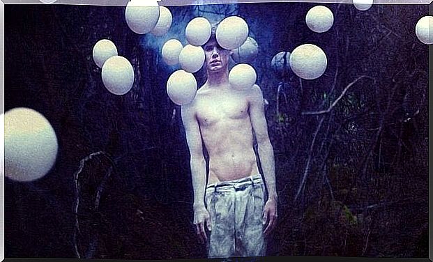 Boy with white balloons around