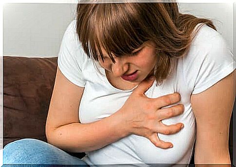 Woman touching her heart during the first panic attack