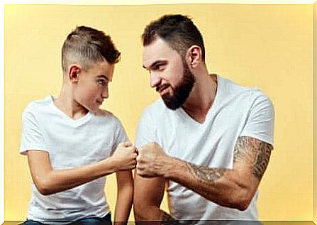 Father and son punch to fist.