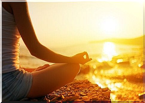 girl meditating in front of the sea