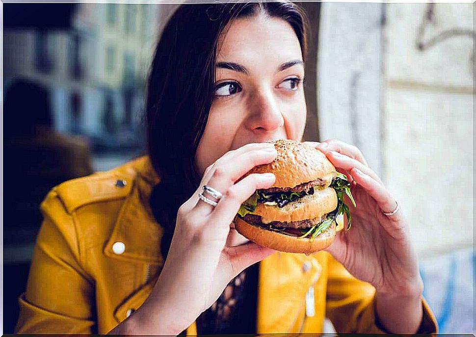 Woman eating hamburger