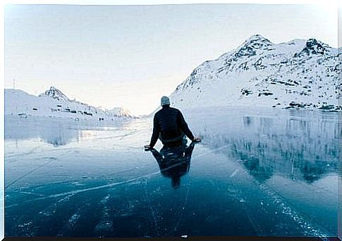 Man sitting on top of the ice