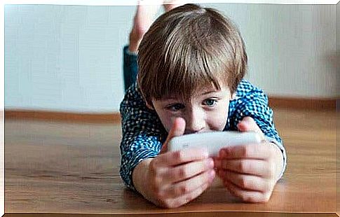 Child playing on cellphone.