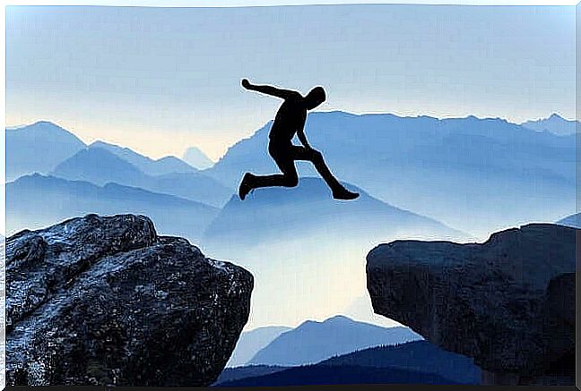 Afraid to jump, man jumps between two rocks