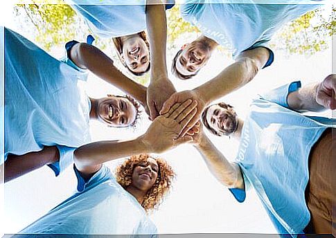 Volunteers in a circle with joined hands