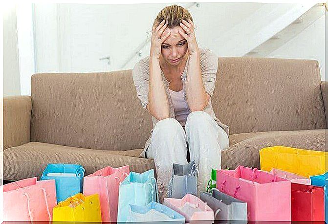 Desperate woman with numerous shopping bags